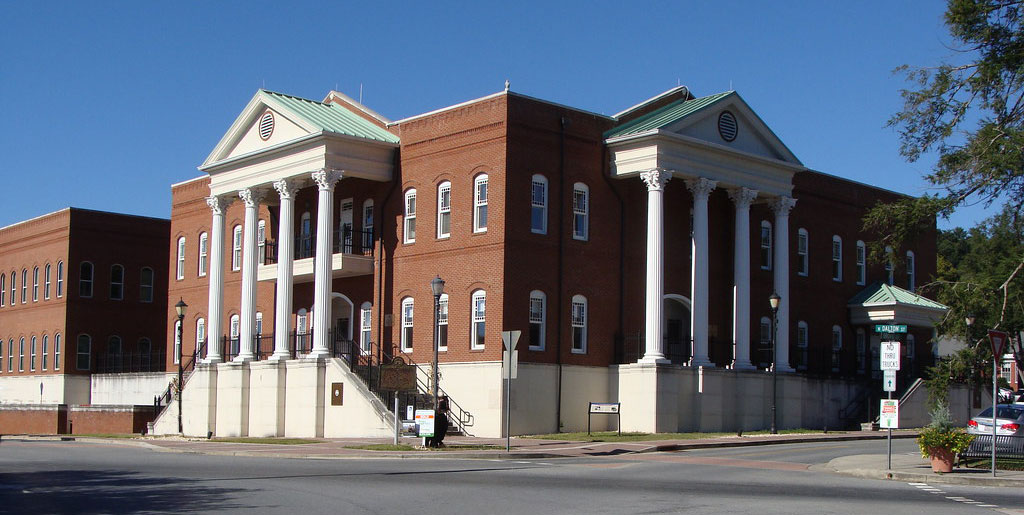 photo of the Gilmer County Courthouse under blue, sunny skies.